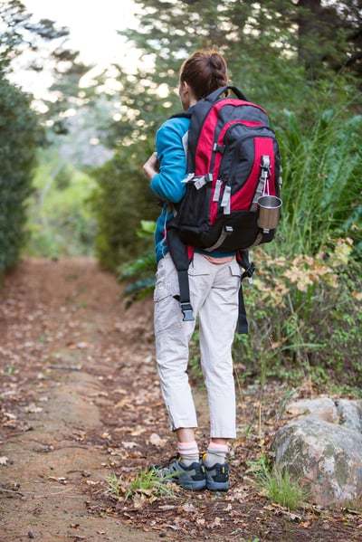 Woman hiking through a forest in the countryside-1